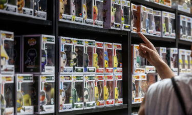 A man points to a shelf of 'Funko Pop' at the tenth edition of DreamHack