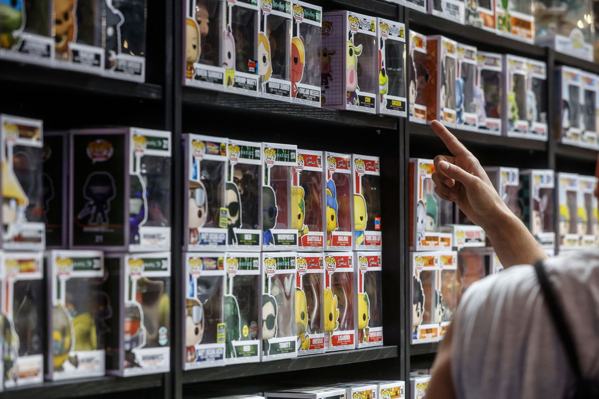 <i>Rober Solsona/Europa Press/Getty Images</i><br/>A man points to a shelf of 'Funko Pop' at the tenth edition of DreamHack