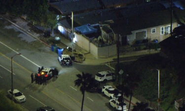 Police respond to the scene of a shooting that left three officers wounded in Los Angeles on March 8.