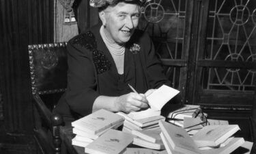 Agatha Christie signs copies of her books in around 1950. Her works are revised to remove racist references and other language considered offensive to modern audiences.