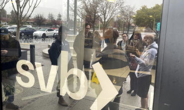 People line up outside of the shuttered Silicon Valley Bank (SVB) headquarters on March 10 in Santa Clara