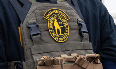 A member of the right-wing group Oath Keepers stands guard during a rally in front of the U.S. Supreme Court Building on January 5