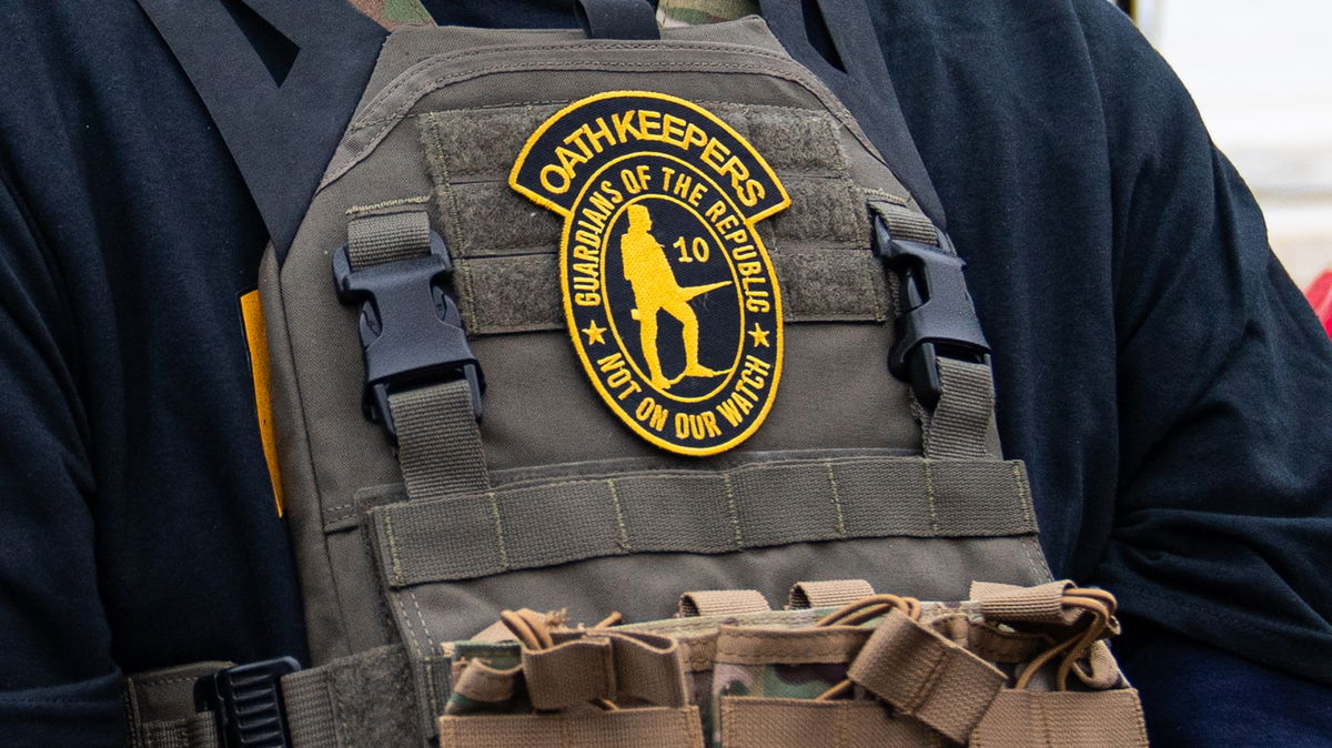 <i>Robert Nickelsberg/Getty Images</i><br/>A member of the right-wing group Oath Keepers stands guard during a rally in front of the U.S. Supreme Court Building on January 5