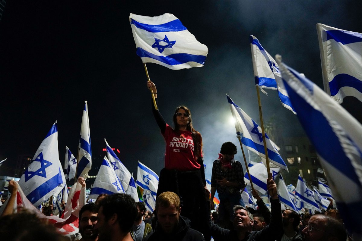 <i>Ohad Zwigenberg/AP</i><br/>Thousands streamed into central Tel Aviv on Sunday night in support of the fired defense minister
