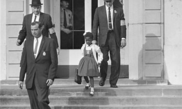 US deputy marshals escort 6-year-old Ruby Bridges from William Frantz Elementary School in New Orleans in November 1960.