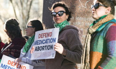 Lindsay London holds a protest sign in support of access to abortion medication outside the Federal Courthouse on March 15 in Amarillo