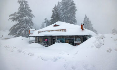 The open sign is still on at a business that's been shut down by heavy snow in Running Springs