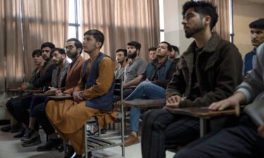 Male students attend a computer science class after universities reopened in Kabul