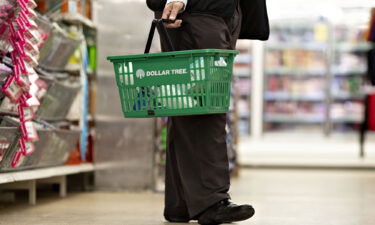 A shopper carries a basket inside a Dollar Tree store in Chicago