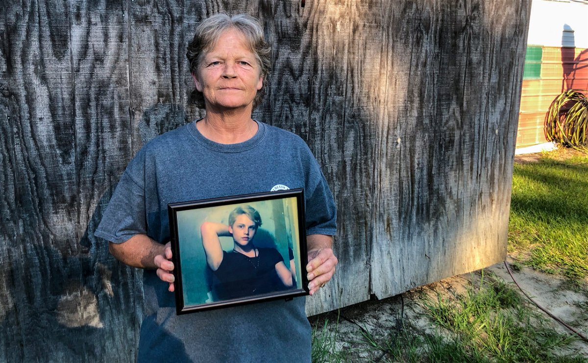 <i>Kacen Bayless/The Island Packet/AP</i><br/>Sandy Smith holds a photo of her late son