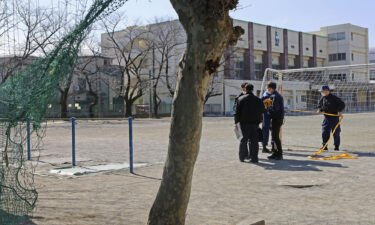 Police investigate an elementary schoolyard in the city of Saitama