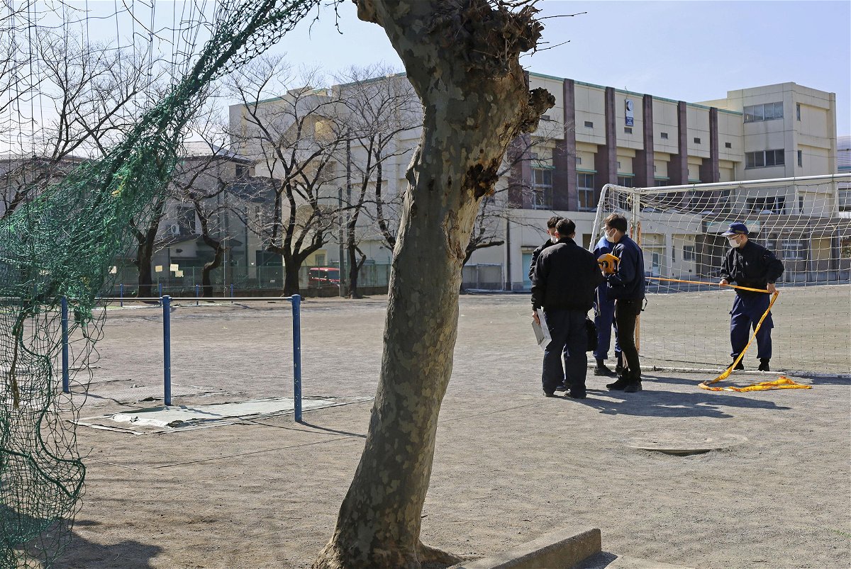 <i>Kyodo News/Getty Images</i><br/>Police investigate an elementary schoolyard in the city of Saitama