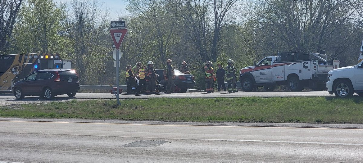 Firefighters surround a car after a crash on Highway 63 north of Columbia on Thursday, April 13, 2023.