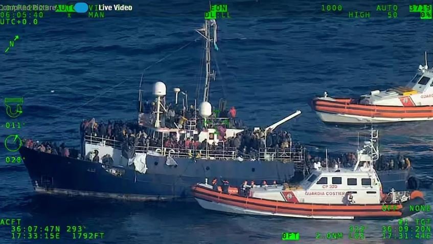 <i>Italian Coast Guard</i><br/>Rescue operations are underway to retrieve hundreds of migrants adrift on a boat in the Mediterranean Sea