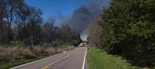 Black smoke rises from a wildfire along Route Z in Boone County on Wednesday, April 12, 2023.