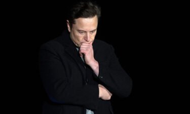 Elon Musk pauses and looks down as he speaks during a press conference at SpaceX's Starbase facility near Boca Chica Village in South Texas on February 10