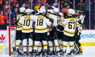 Boston Bruins gather around Jeremy Swayman as they celebrates their win against the Philadelphia Flyers on Sunday