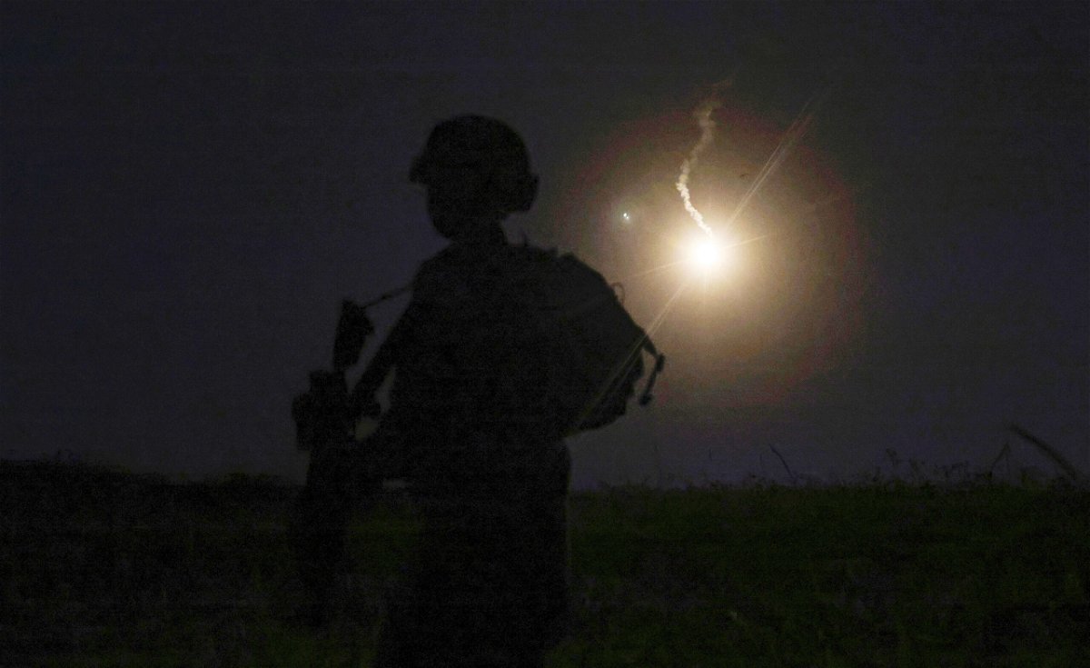 <i>Jalaa Marey/AFP/Getty Images</i><br/>The silhouette of an Israeli soldier is outlined in the sky by a flare fired to search for a rocket that landed near Kibbutz Meitsar in the Golan Heights on April 9