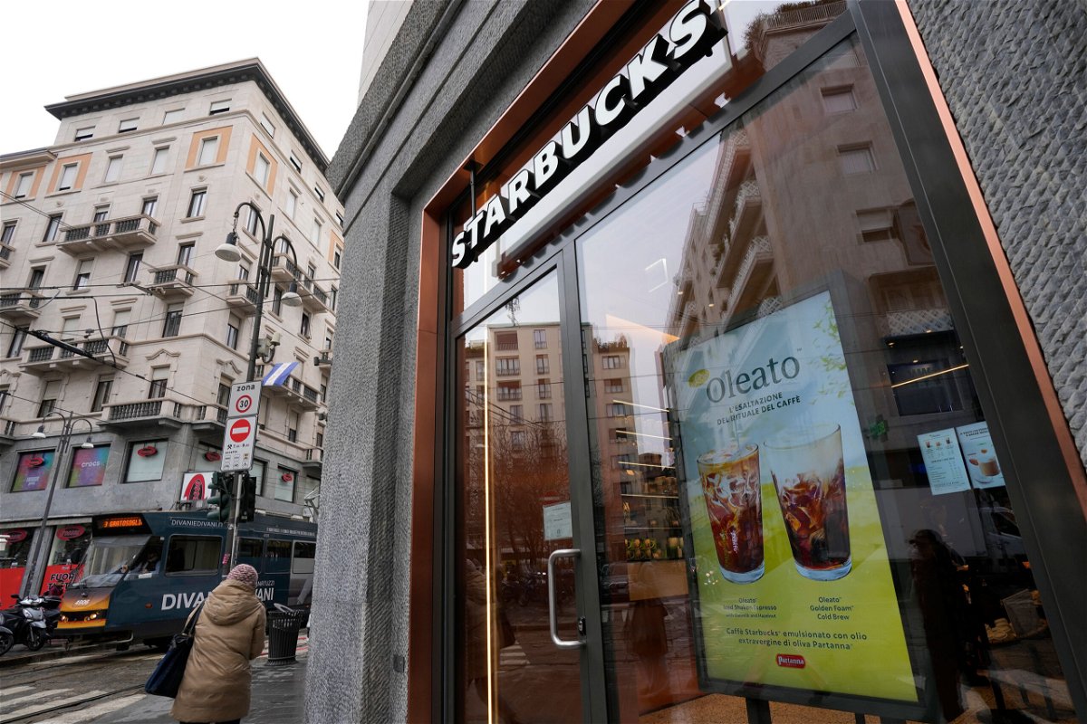 <i>Antonio Calanni/AP</i><br/>A Starbucks sign advertises the company's Oleato coffee in one of their coffee shops in Milan