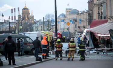 Emergency service workers stand at the site of the blast at the St. Petersburg cafe on Sunday. Russian authorities have