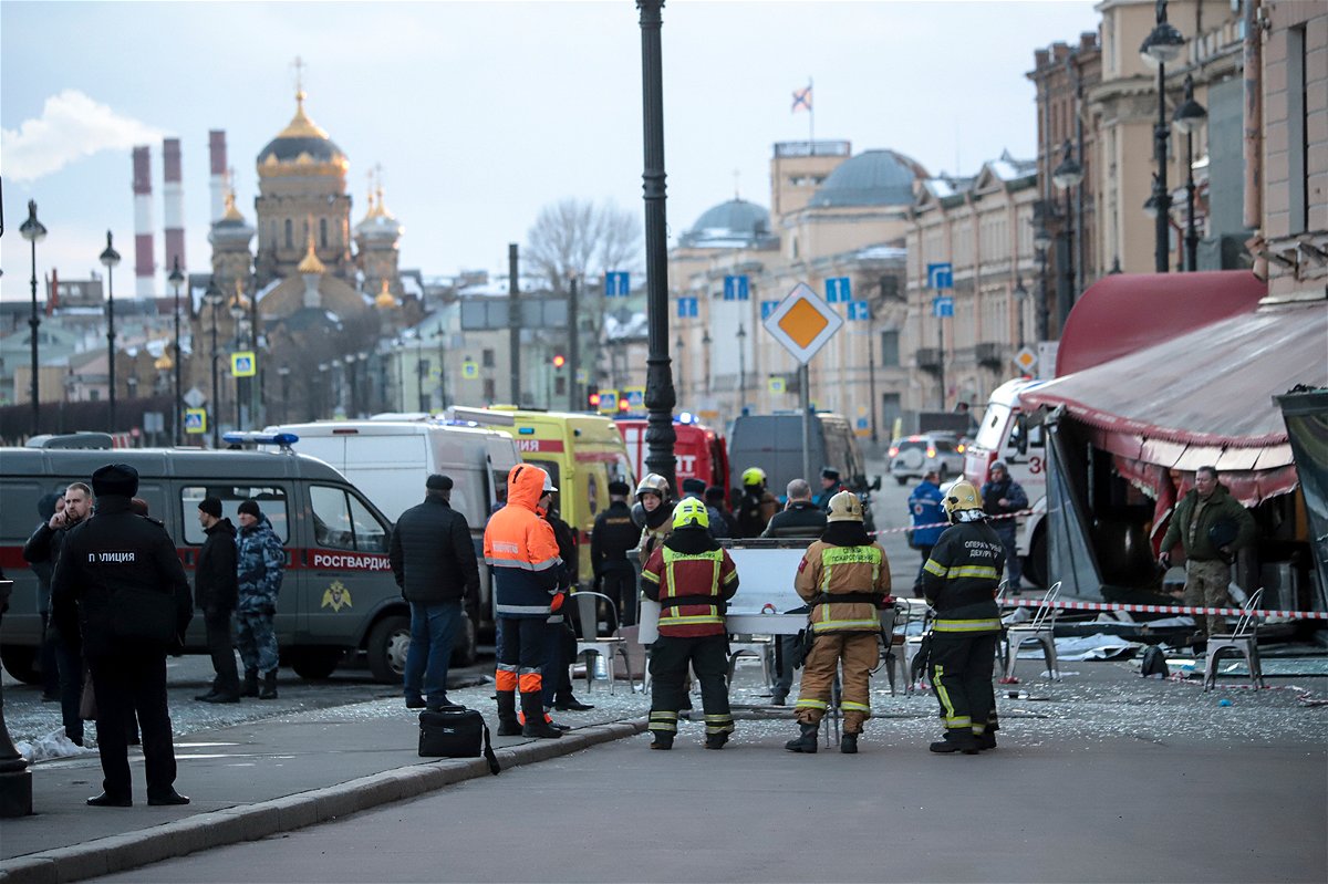 Emergency service workers stand at the site of the blast at the St. Petersburg cafe on Sunday. Russian authorities have