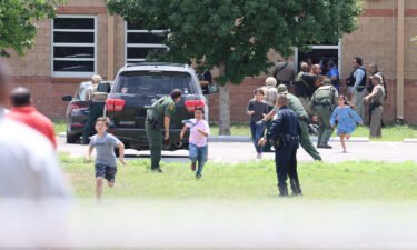 Students run to safety after escaping from a window at Robb Elementary School on May 24.