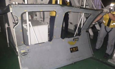 This photo provided by the 11th Regional Japan Coast Guard Headquarters shows a door that the coast guard retrieved from the sea