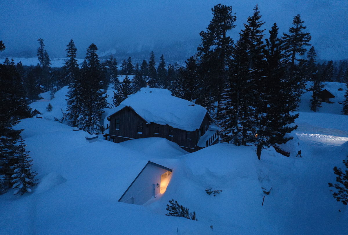 <i>Mario Tama/Getty Images</i><br/>A person shovels snow in Mammoth Lakes in late March.