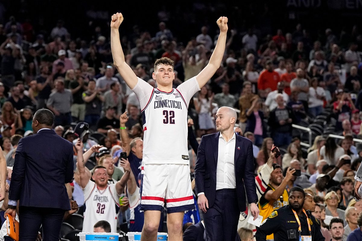 <i>Brynn Anderson/AP</i><br/>Connecticut center Donovan Clingan celebrates after defeating  Miami.