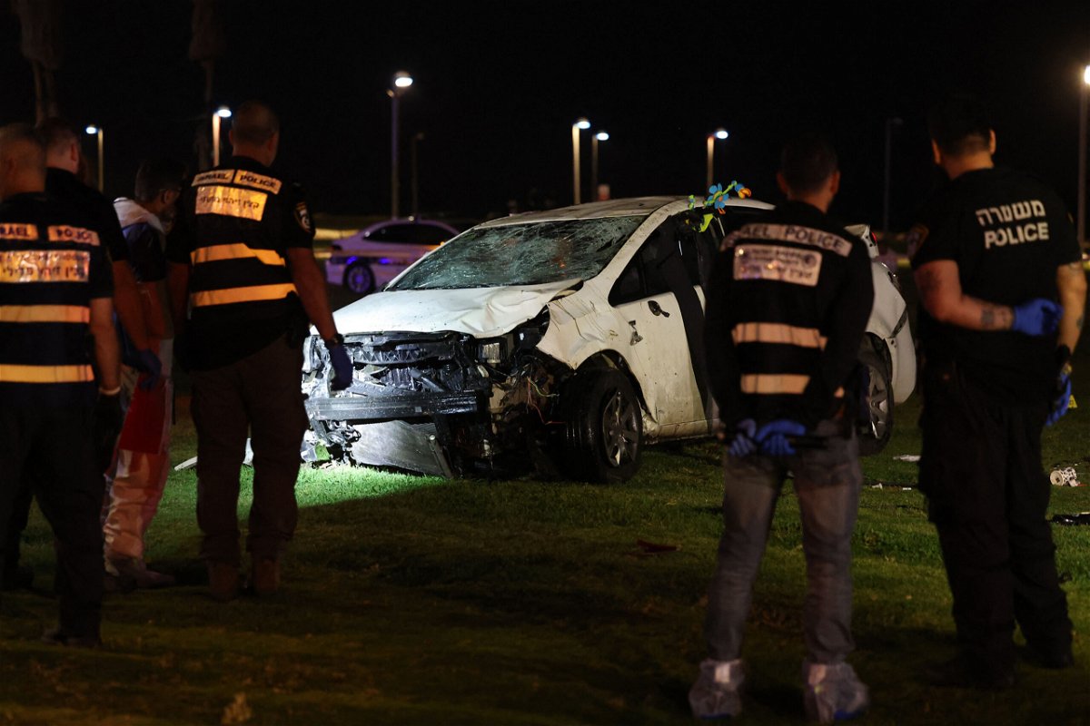 <i>Ahmad Gharabli/AFP/Getty Images</i><br/>Israeli police gather next to a car used in a ramming attack in Tel Aviv on April 7.