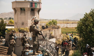 US Marines assist with security at an evacuation control checkpoint during an evacuation at Hamid Karzai International Airport in Kabul