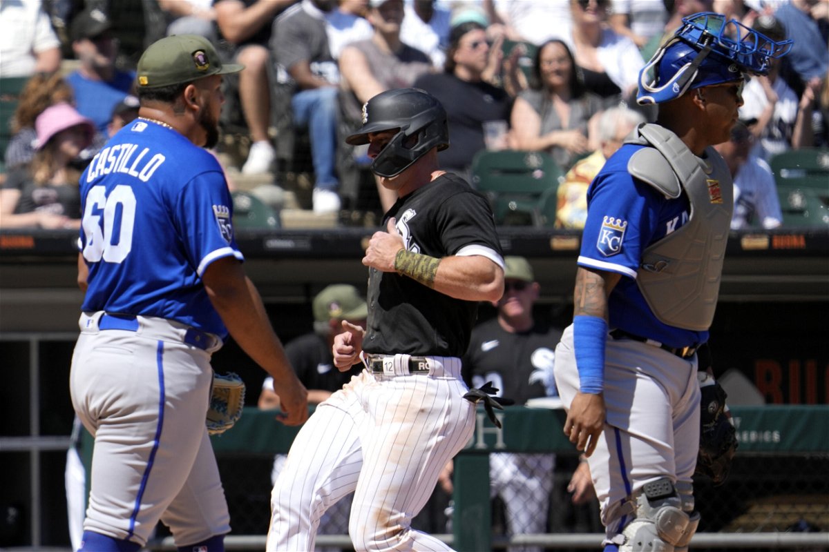Chicago White Sox's Romy Gonzalez, center, scores on a sacrifice fly by Andrew Benintendi, center, as Kansas City Royals relief pitcher Max Castillo, left, and catcher Salvador Perez look to left field during the fifth inning of a baseball game in Chicago, Sunday, May 21, 2023. (AP Photo/Nam Y. Huh)