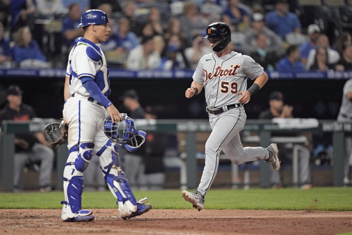 Detroit Tigers' Zack Short (59) crosses the plate past Kansas City Royals catcher Freddy Fermin to score on a double by Jonathan Schoop during the seventh inning of a baseball game Wednesday, May 24, 2023, in Kansas City, Mo. 