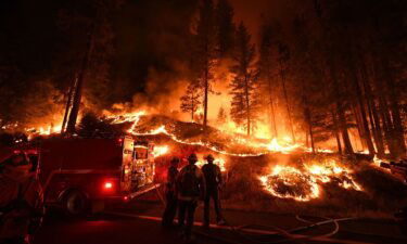 Firefighters try to control a back burn as the Carr fire continues to spread towards the towns of Douglas City and Lewiston near Redding