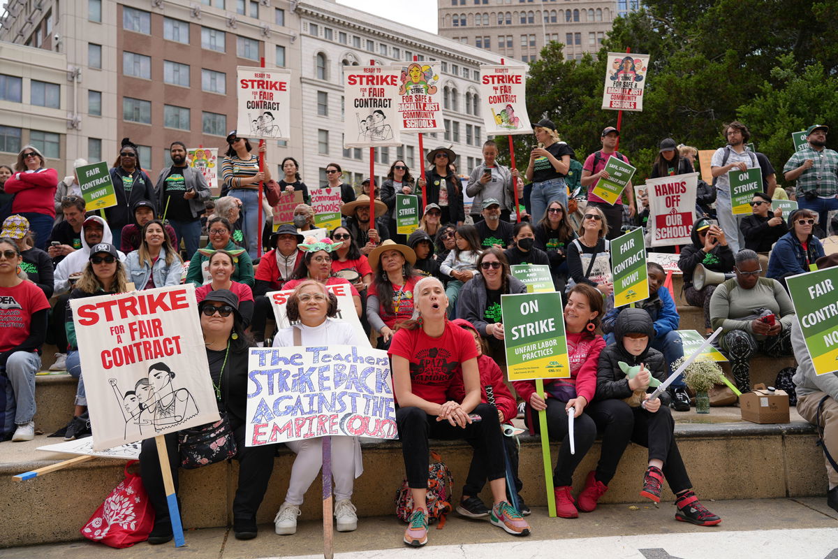 <i>Terry Chea/AP</i><br/>Striking teachers hold a rally outside Oakland's City Hall on May 4.