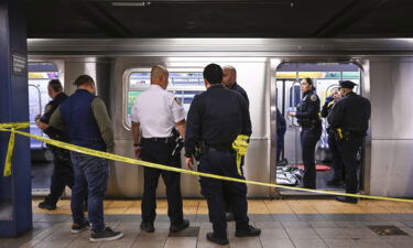 New York police officers respond after a man riding the subway was placed in a chokehold by another passenger on Monday.