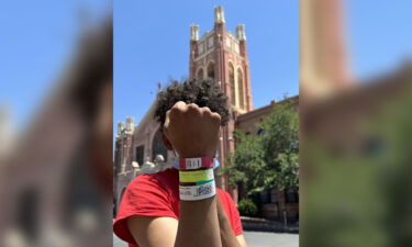 Venezuelan migrant Enderson Amaya Blanco shows bracelets assigned throughout the detention process