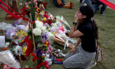 A mourner at a makeshift memorial at the Allen Premium Outlets on Monday