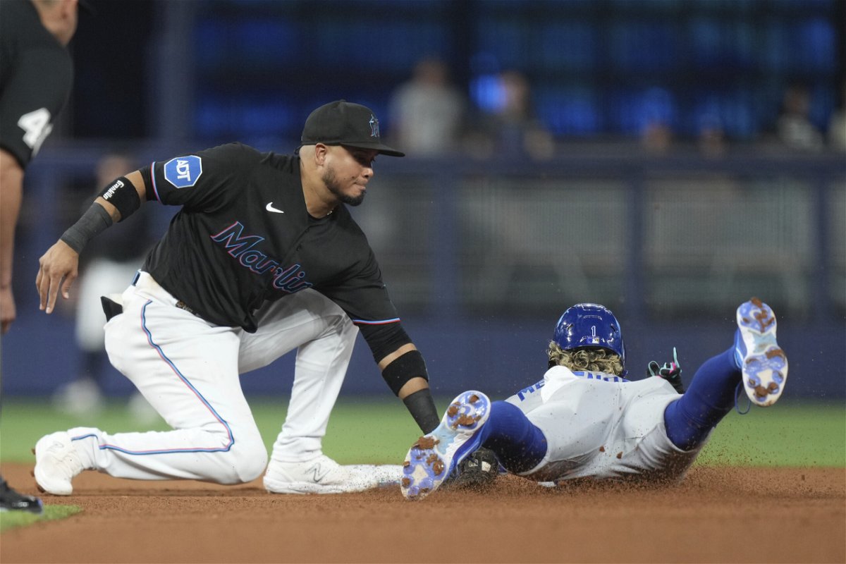 Miami Marlins second baseman Luis Arraez (3) tags out Kansas City Royals' MJ Melendez (1) trying to steal second base during the fourth inning of a baseball game Wednesday, June 7, 2023, in Miami. 