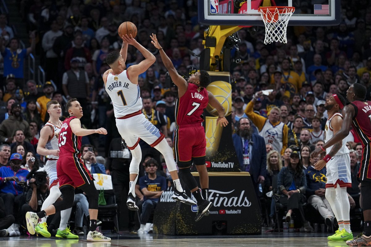 Denver Nuggets forward Michael Porter Jr. (1) shoots over Miami Heat guard Kyle Lowry (7) during the first half of Game 5 of basketball's NBA Finals, Monday, June 12, 2023, in Denver. 