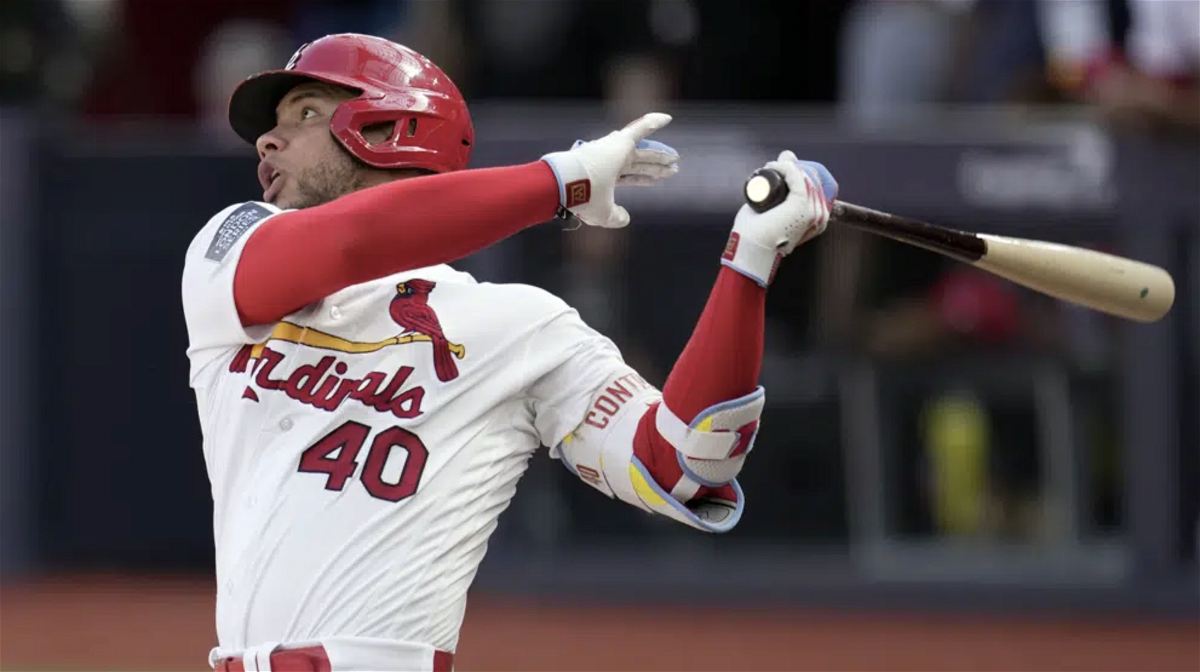 St. Louis Cardinals' Willson Contreras follows through as he singles during the third inning of a baseball game against the Chicago Cubs Sunday, June 25, 2023, in London. 
