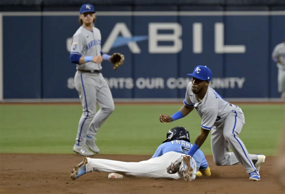 Kansas City Royals shortstop Bobby Witt Jr., left, looks on as Tampa Bay Rays' Wander Franco, bottom right, beats a tag by Royals second baseman Samad Taylor for a stolen base during the fourth inning of a baseball game Sunday, June 25, 2023, in St. Petersburg, Fla. 