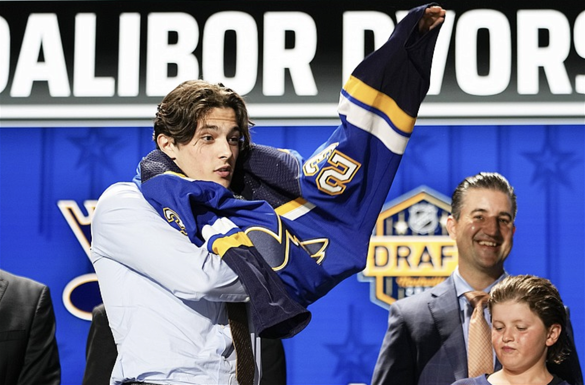 Dalibor Dvorsky puts on a Blues jersey Wednesday night after being picked by the team during the first round of the NHL Draft in Nashville, Tenn. (The Associated Press)