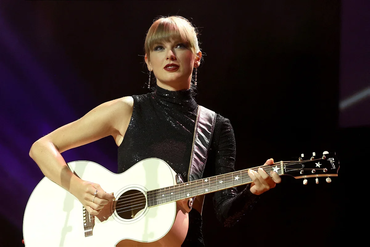 This file photo shows Taylor Swift playing a guitar. Missouri Attorney General Andrew Bailey gave a heads up to consumers to be aware of possible scams if they try to buy last-minute tickets to her shows at Arrowhead Stadium next month.