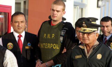 Joran van der Sloot (center) is escorted by Peruvian police on June 4