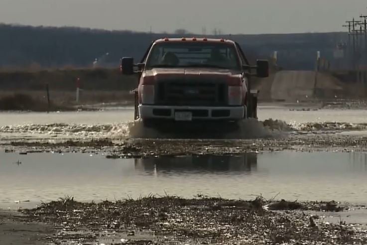 FILE - A farm truck drives through Missouri River floodwater.