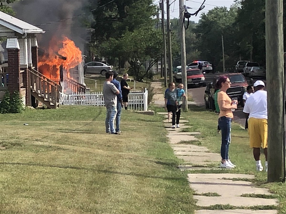 Flames pour from a residence near Eighth Street and Grand Avenue in Fulton on Monday, July 3, 2023.