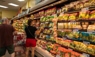 People shop for fresh vegetables at a Trader Joe's supermarket in South Burlington
