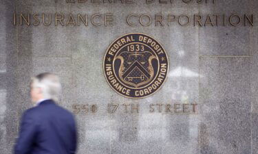 A pedestrian walks outside the headquarters of the U.S. Federal Deposit Insurance Corp.
