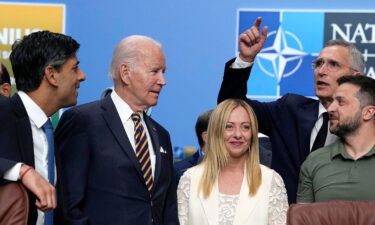 President Joe Biden and Italy's Prime Minister Giorgia Meloni wait to have their photo taken during a NATO summit in Vilnius